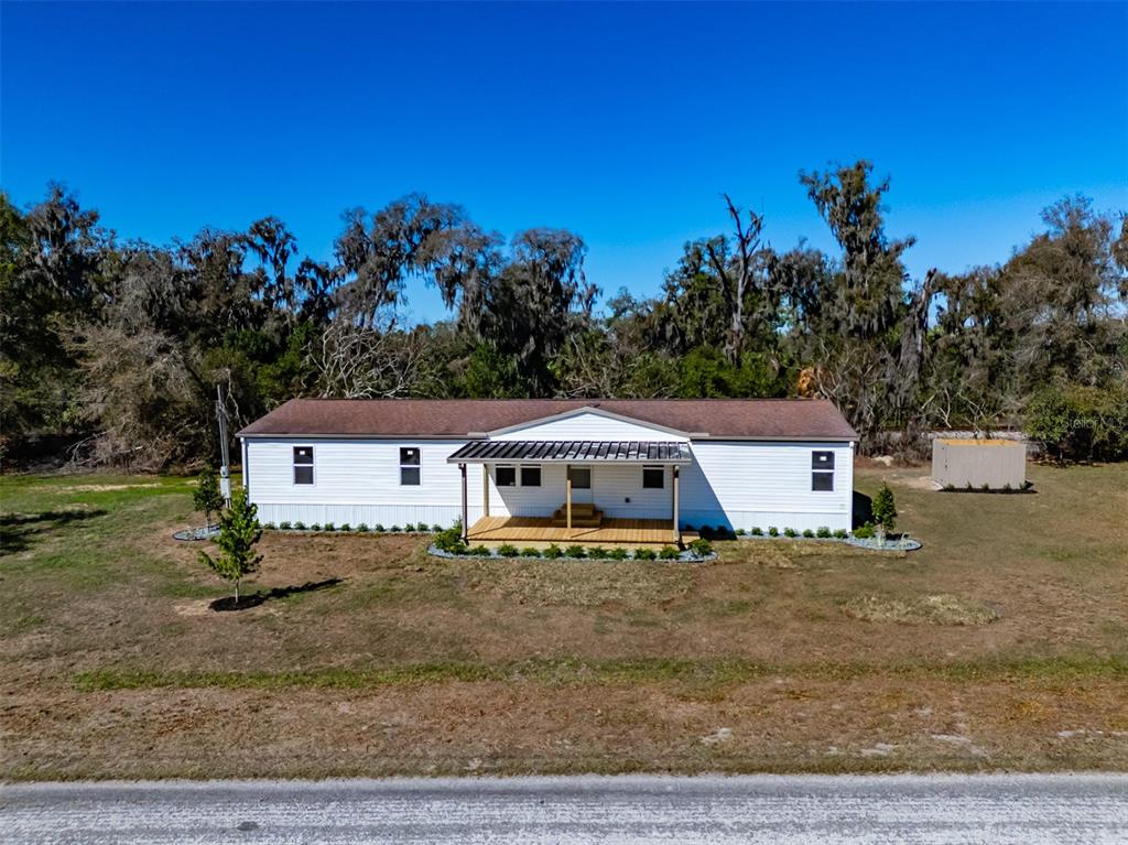 8301 Henry George Road Plant City, FL 33567 - Photo 39 of 51 a white house that has a tree in front of it