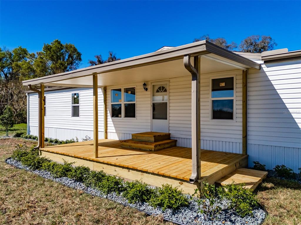 8301 Henry George Road Plant City, FL 33567 - Photo 4 of 51 a front view of a house with garden
