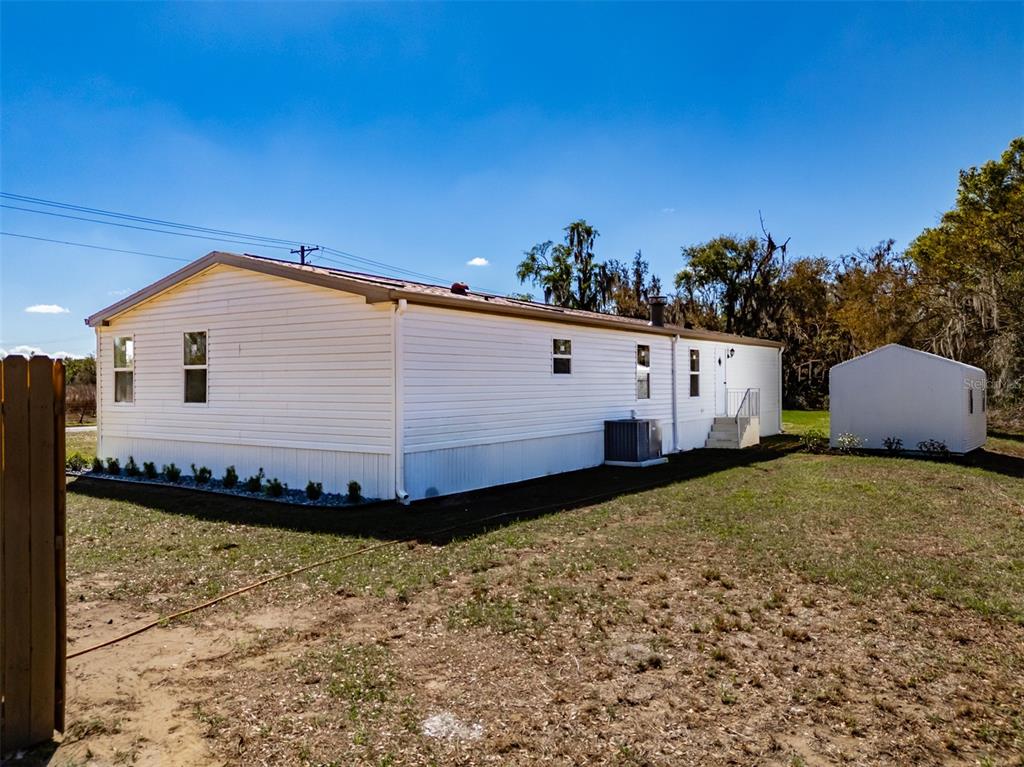 8301 Henry George Road Plant City, FL 33567 - Photo 49 of 51 a front view of a house with a yard