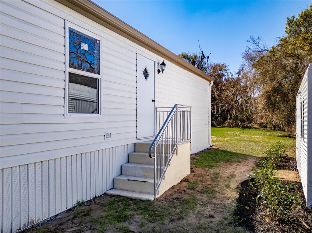 8301 Henry George Road Plant City, FL 33567 - Photo 50 of 51 a view of a house with backyard and trees