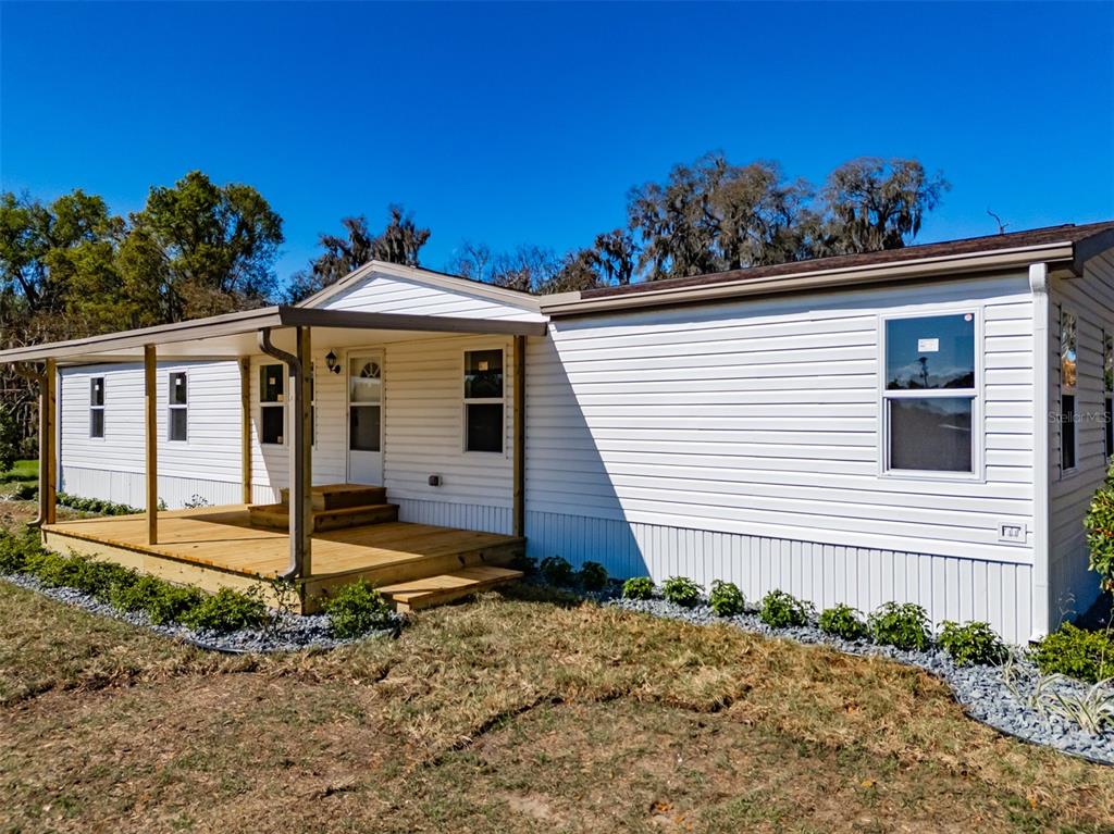 8301 Henry George Road Plant City, FL 33567 - Photo 5 of 51 a front view of a house with garden