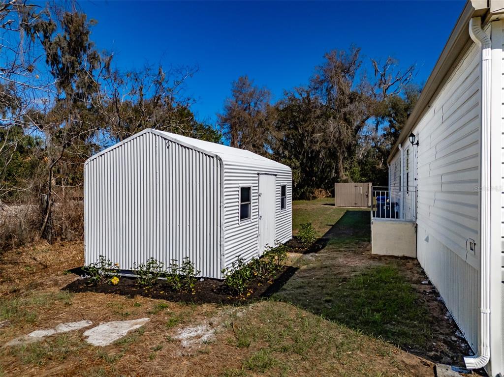 8301 Henry George Road Plant City, FL 33567 - Photo 51 of 51 a view of a house with a yard