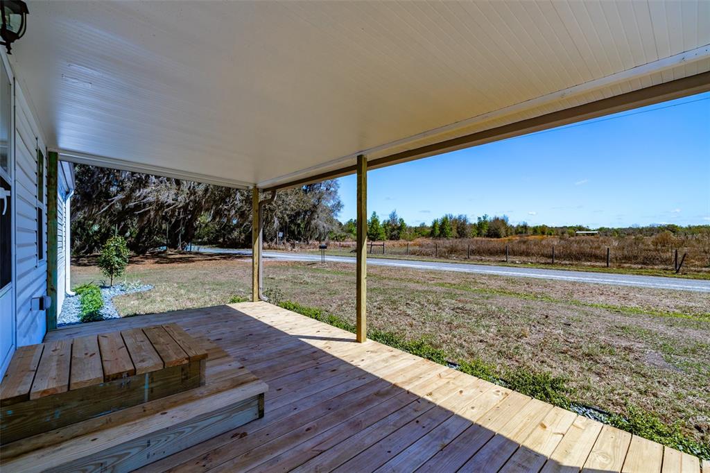 8301 Henry George Road Plant City, FL 33567 - Photo 6 of 51 a view of a back yard from a balcony