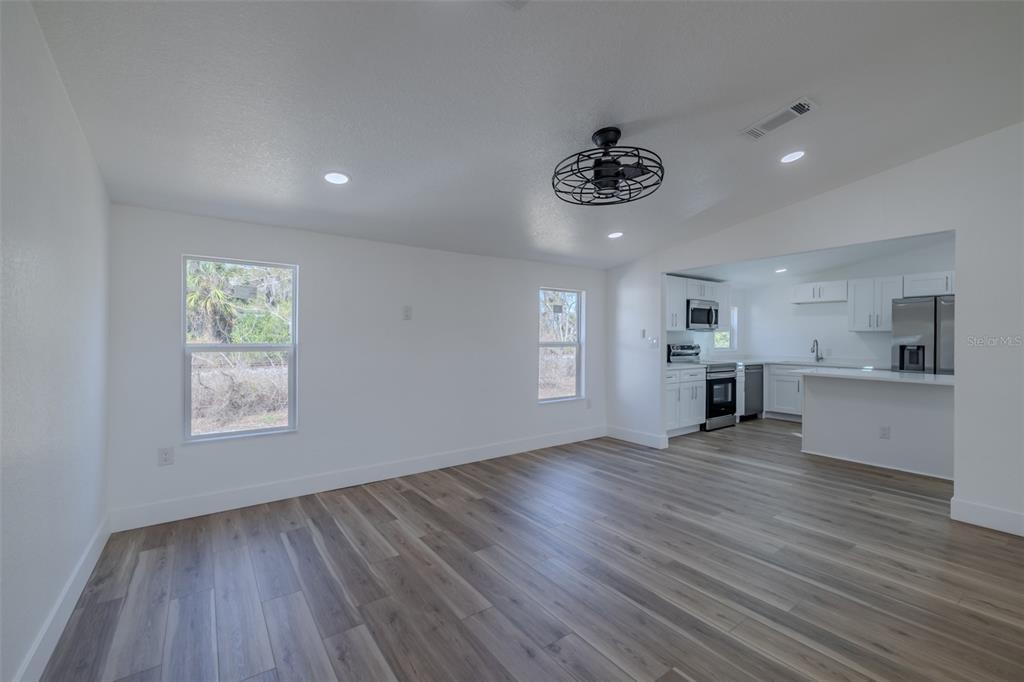 8301 Henry George Road Plant City, FL 33567 - Photo 9 of 51 a view of an empty room and window and wooden floor