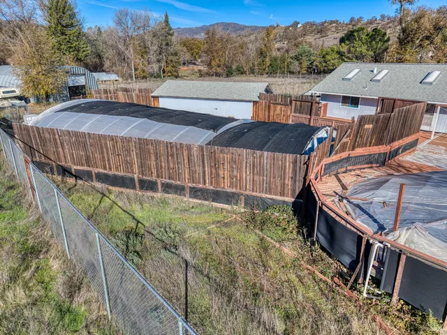 a view of a big yard with large trees
