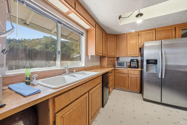 a kitchen with granite countertop a stove and a sink