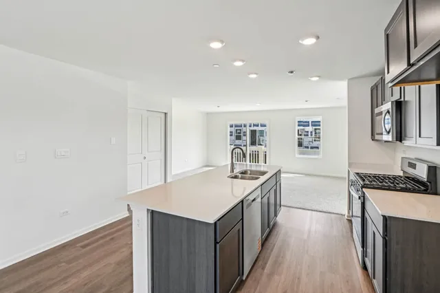 a kitchen with granite countertop a sink and wooden floor