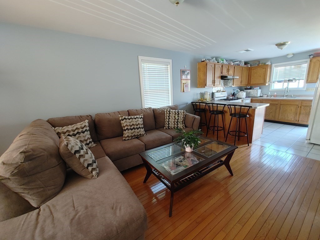 389 4th Street Fall River, MA 02721 - Photo 12 of 30 a living room with furniture and wooden floor