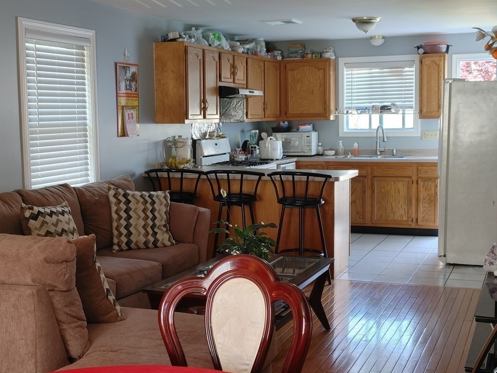 389 4th Street Fall River, MA 02721 - Photo 13 of 30 a kitchen with stainless steel appliances granite countertop a stove a sink and a microwave