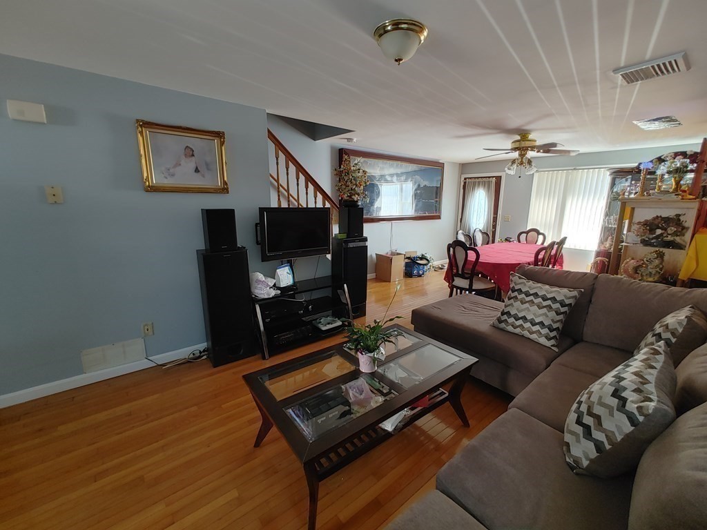 389 4th Street Fall River, MA 02721 - Photo 14 of 30 a living room with furniture a flat screen tv and a table