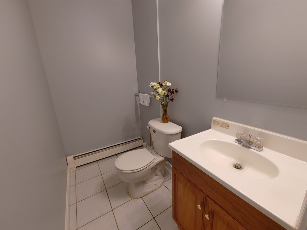 389 4th Street Fall River, MA 02721 - Photo 15 of 30 a bathroom with a sink toilet and a mirror