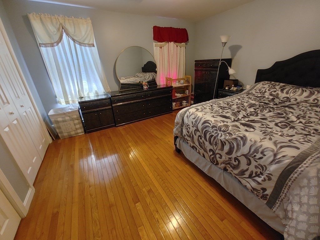 389 4th Street Fall River, MA 02721 - Photo 18 of 30 a bedroom with a bed and dresser with wooden floor