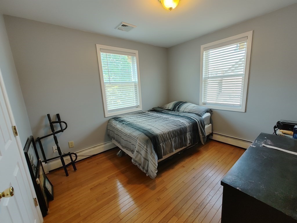 389 4th Street Fall River, MA 02721 - Photo 21 of 30 a bed sitting in a bedroom next to a window