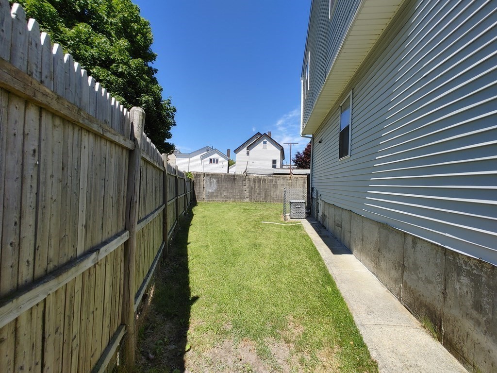 389 4th Street Fall River, MA 02721 - Photo 26 of 30 a view of a yard with wooden fence