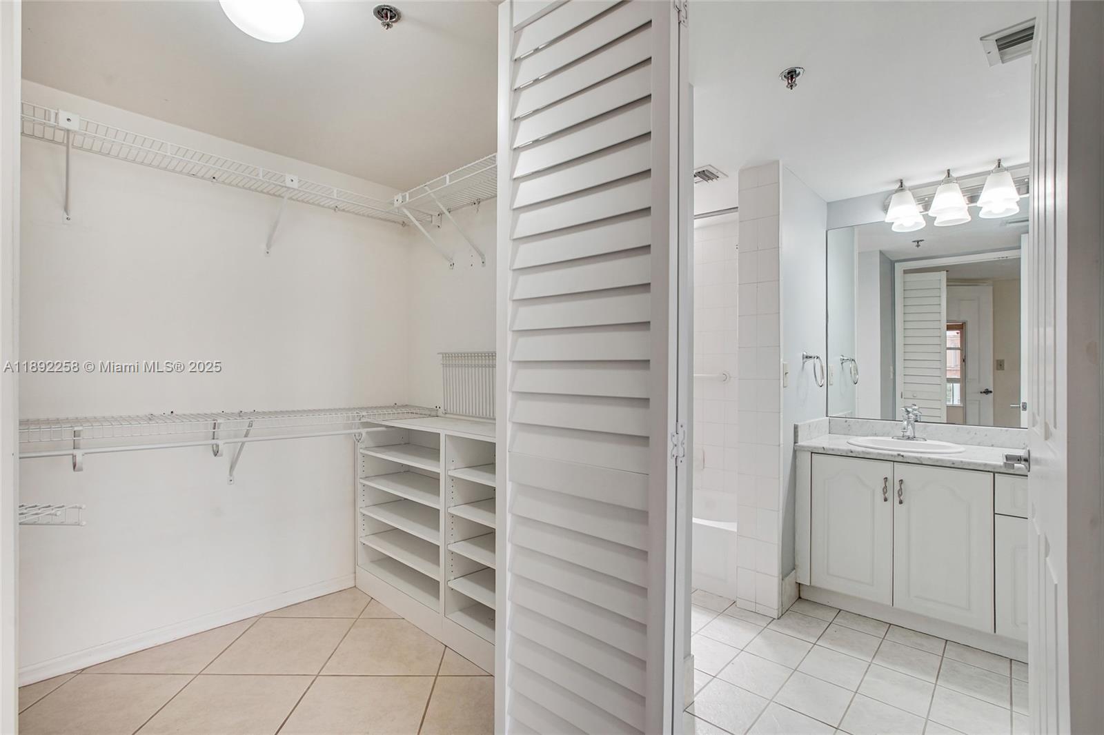 2351 Douglas Road, Unit 604 Miami, FL 33145 - Photo 15 of 26 a view of walk in closet with empty racks