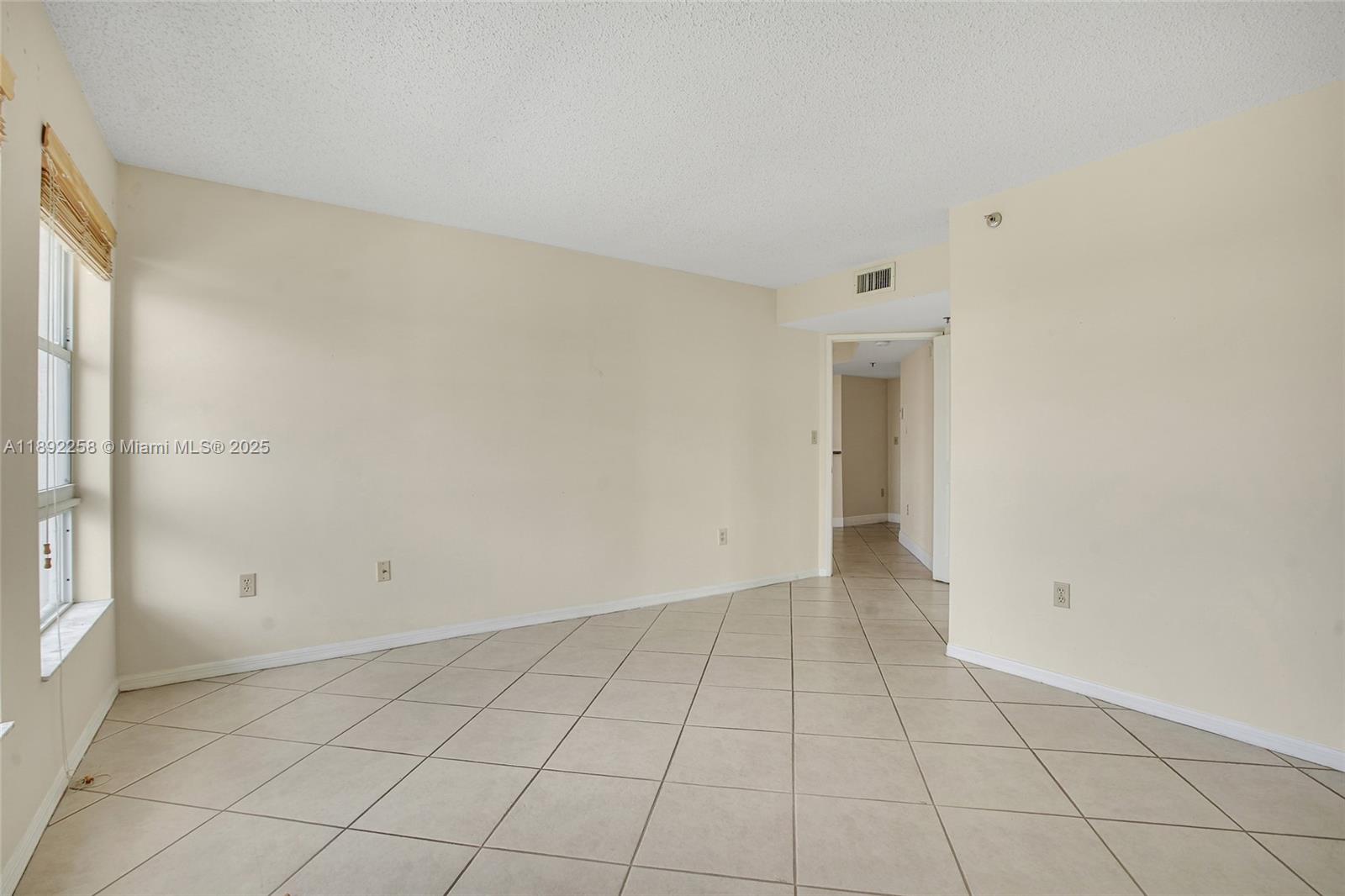 2351 Douglas Road, Unit 604 Miami, FL 33145 - Photo 17 of 26 an empty room with white walls and tiles