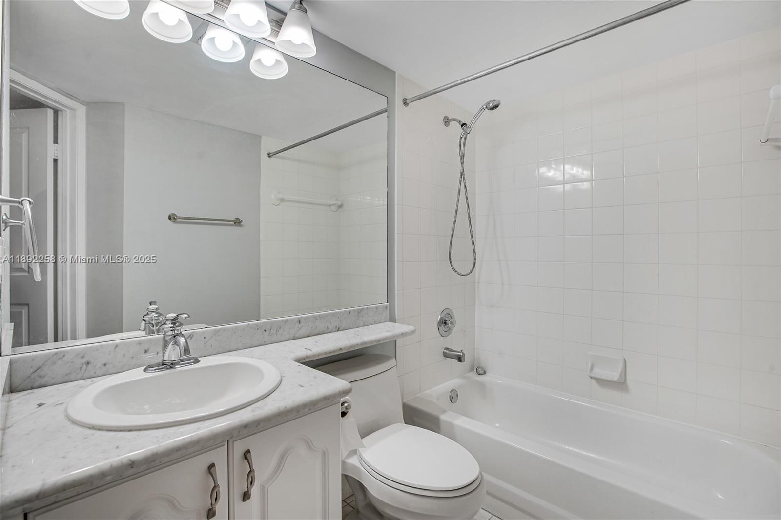 2351 Douglas Road, Unit 604 Miami, FL 33145 - Photo 18 of 26 a bathroom with a sink a toilet and a bathtub
