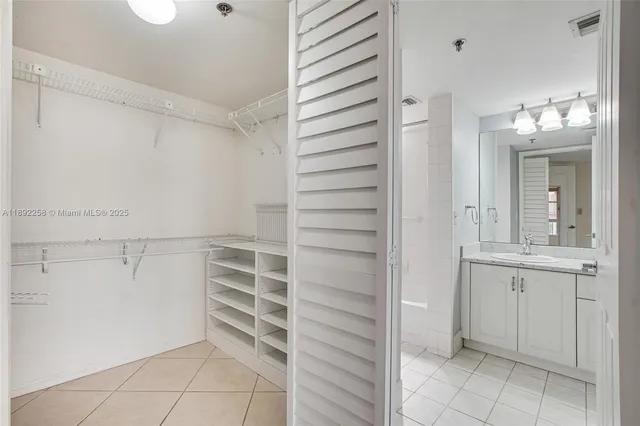 a view of walk in closet with empty racks