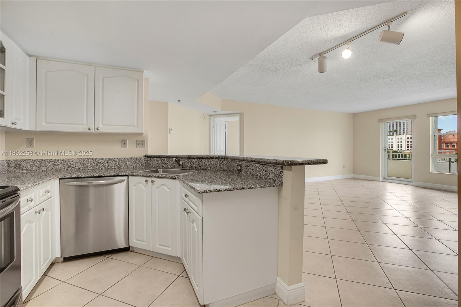 2351 Douglas Road, Unit 604 Miami, FL 33145 - Photo 10 of 26 a kitchen with a sink cabinets and appliances