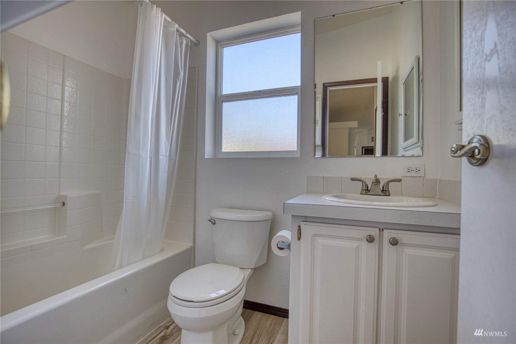 1019 Stanford Drive, Unit 26 Cosmopolis, WA 98537 - Photo 14 of 20 a bathroom with a granite countertop toilet a sink and a mirror