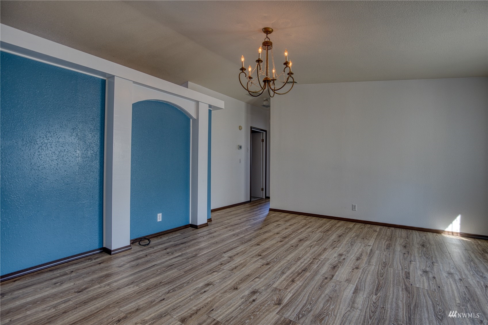 1019 Stanford Drive, Unit 26 Cosmopolis, WA 98537 - Photo 2 of 20 a view of a room with wooden floor and chandelier