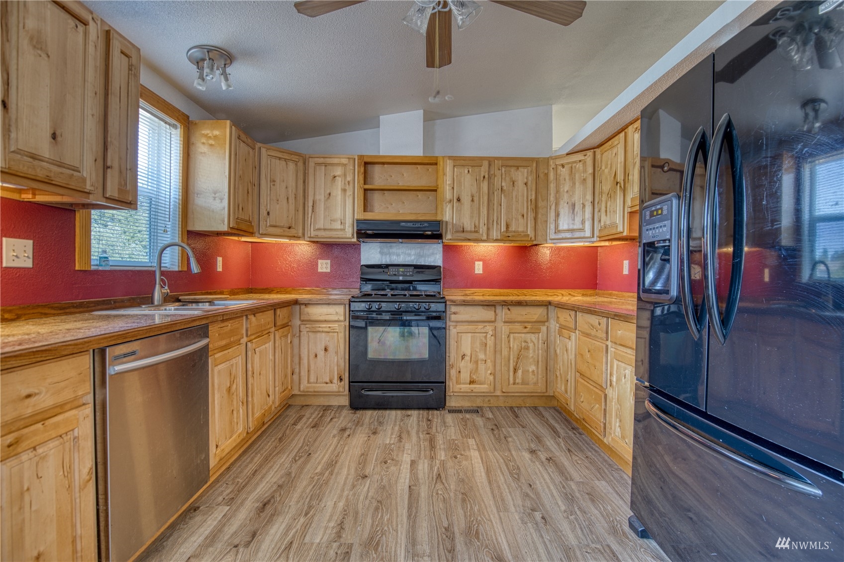 1019 Stanford Drive, Unit 26 Cosmopolis, WA 98537 - Photo 3 of 20 a kitchen with a sink cabinets stainless steel appliances and window