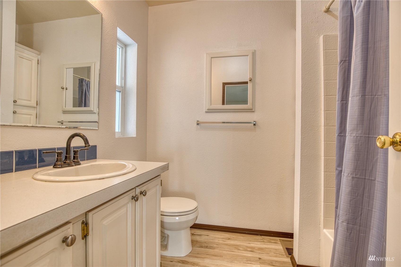 1019 Stanford Drive, Unit 26 Cosmopolis, WA 98537 - Photo 5 of 20 a bathroom with a granite countertop sink a toilet and a mirror