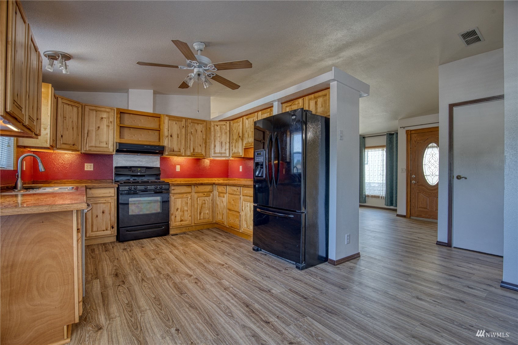 1019 Stanford Drive, Unit 26 Cosmopolis, WA 98537 - Photo 8 of 20 a kitchen with stainless steel appliances a stove cabinets and wooden floor