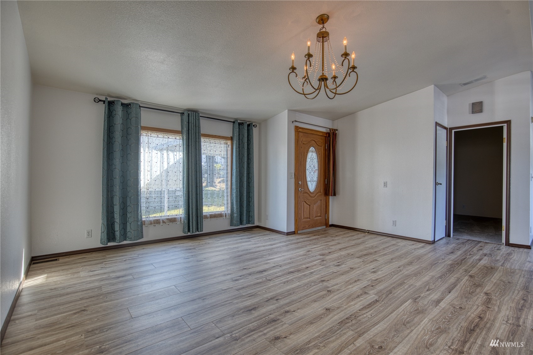 1019 Stanford Drive, Unit 26 Cosmopolis, WA 98537 - Photo 9 of 20 a view of an empty room with a window and wooden floor