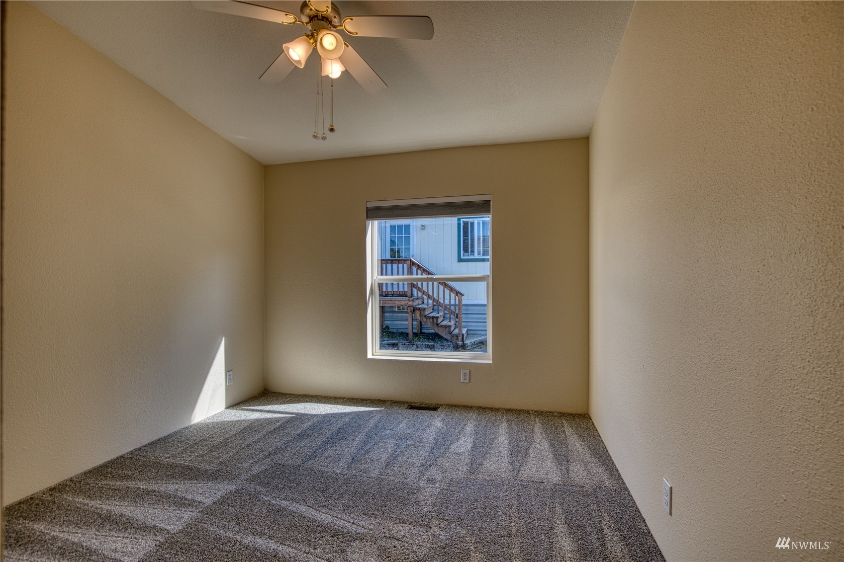 1019 Stanford Drive, Unit 26 Cosmopolis, WA 98537 - Photo 10 of 20 a view of an empty room with window and chandelier fan