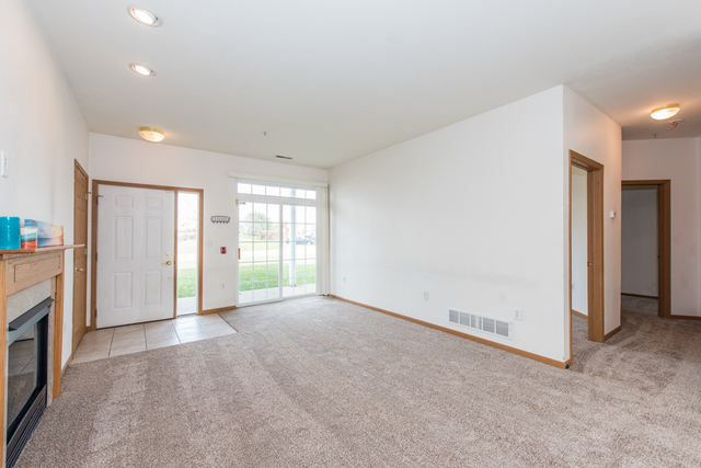 6739 Meadowlands Circle, Unit 6A Pleasant Prairie, WI 53158 - Photo 2 of 19 a view of an empty room with a fireplace