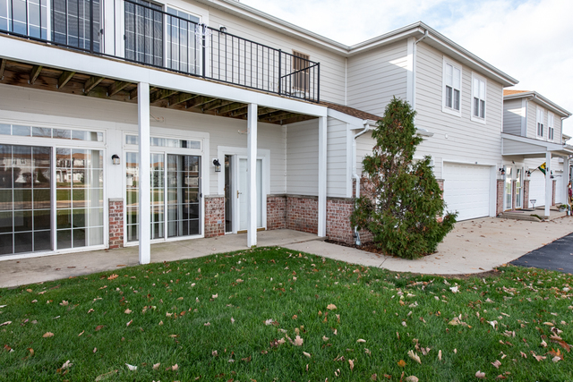 6739 Meadowlands Circle, Unit 6A Pleasant Prairie, WI 53158 - Photo 18 of 19 front view of a house with a yard