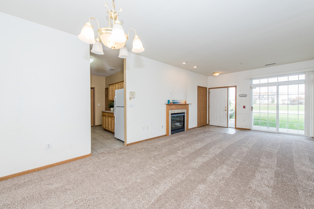 6739 Meadowlands Circle, Unit 6A Pleasant Prairie, WI 53158 - Photo 5 of 19 a view of an empty room with a window