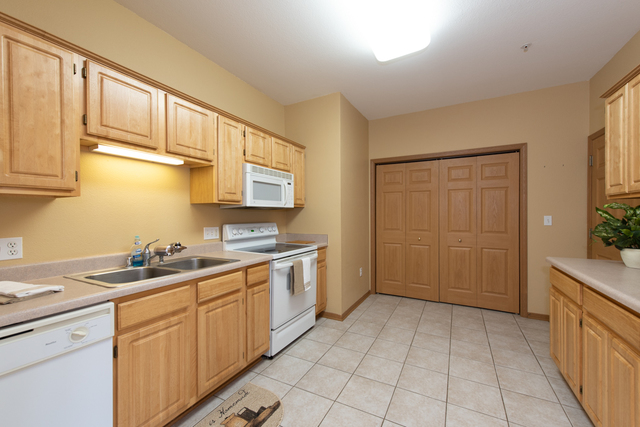 6739 Meadowlands Circle, Unit 6A Pleasant Prairie, WI 53158 - Photo 7 of 19 a kitchen with a sink and cabinets