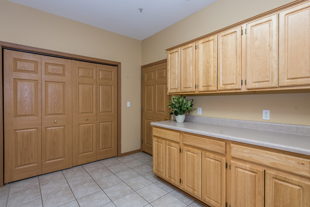 6739 Meadowlands Circle, Unit 6A Pleasant Prairie, WI 53158 - Photo 8 of 19 a view of a kitchen with white cabinets