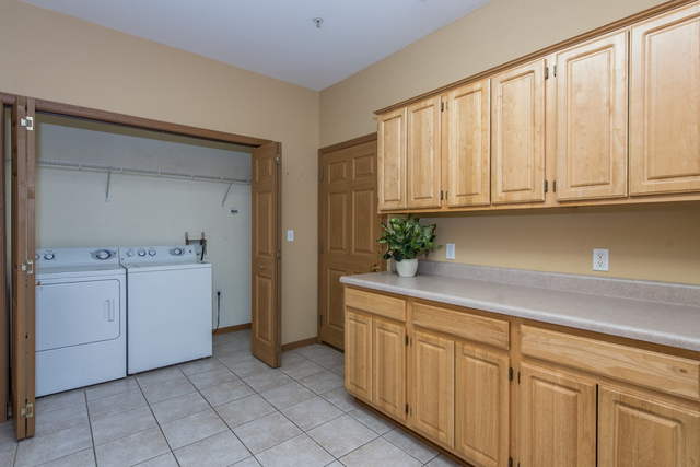 6739 Meadowlands Circle, Unit 6A Pleasant Prairie, WI 53158 - Photo 9 of 19 a utility room with cabinets