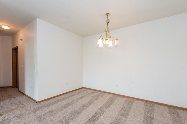 6739 Meadowlands Circle, Unit 6A Pleasant Prairie, WI 53158 - Photo 10 of 19 a view of empty room with wooden floor