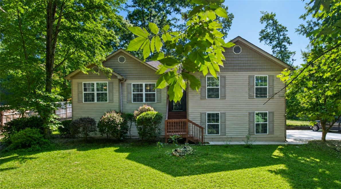 151 Towne Creek Trail Anderson, SC 29621 - Photo 1 of 49 A split-level home with a lush front lawn and mature trees offers a welcoming facade.