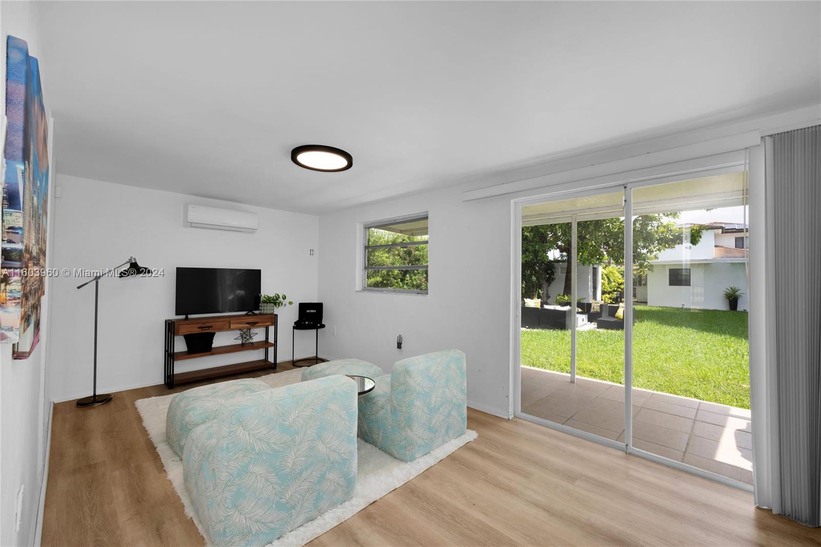 6335 Southwest 33rd Street Miami, FL 33155 - Photo 23 of 37 Family Room with full bath. Could be used as 3rd Bedroom. Glass sliding door to backyard patio and outdoor gathering space.