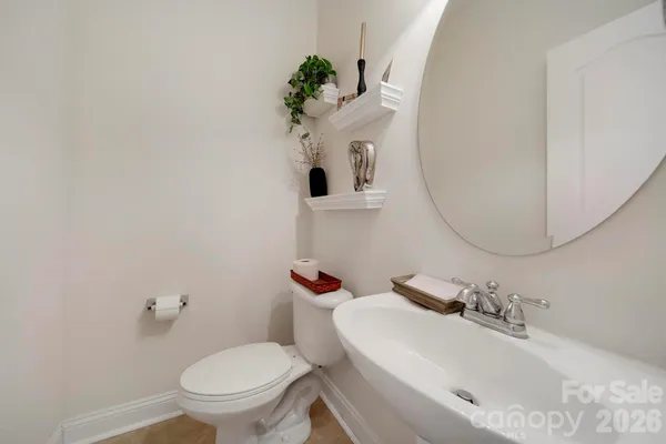 a bathroom with a sink mirror vanity and toilet
