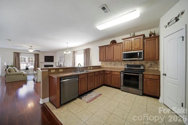 a large kitchen with stainless steel appliances and a refrigerator