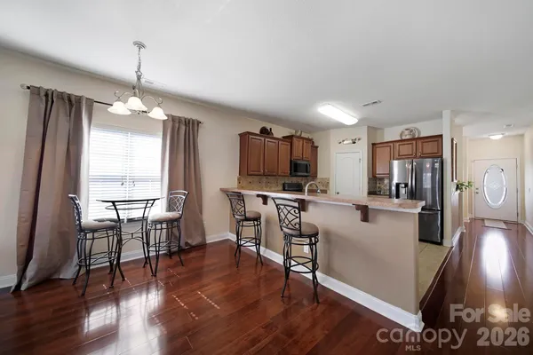 a view of a dining room with furniture window and wooden floor