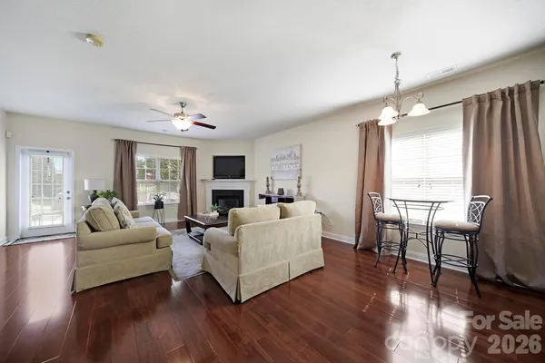 a living room with furniture flat screen tv and wooden floor