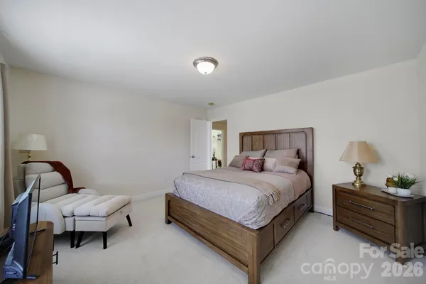 a bedroom with a bed and lamp