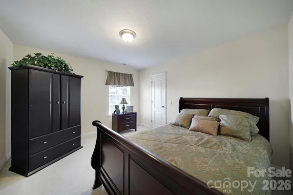 a bedroom with a bed and a large mirror