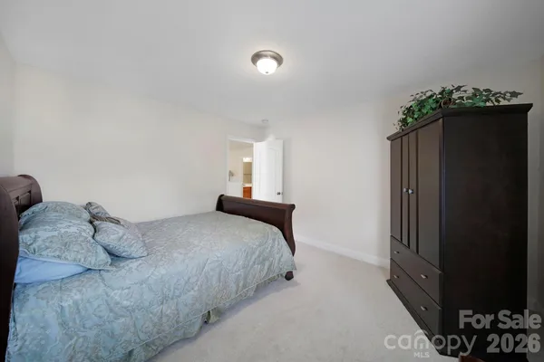 a bedroom with a bed and a potted plant