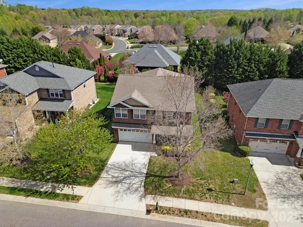 an aerial view of a house with a yard