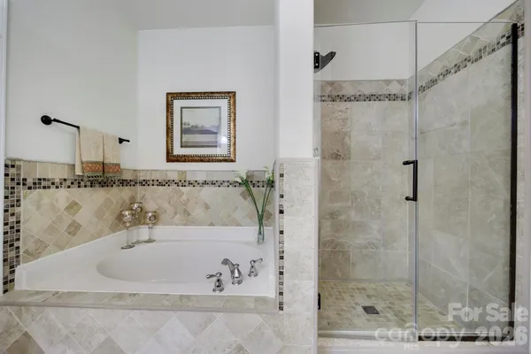 a bathroom with a bathtub and shower