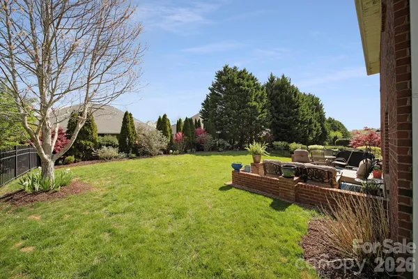 a backyard of a house with table and chairs