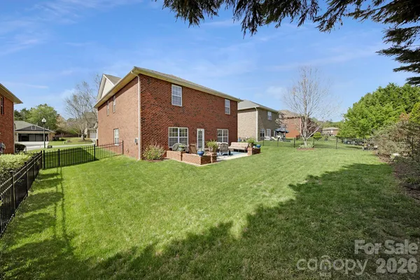 a backyard of a house with table and chairs